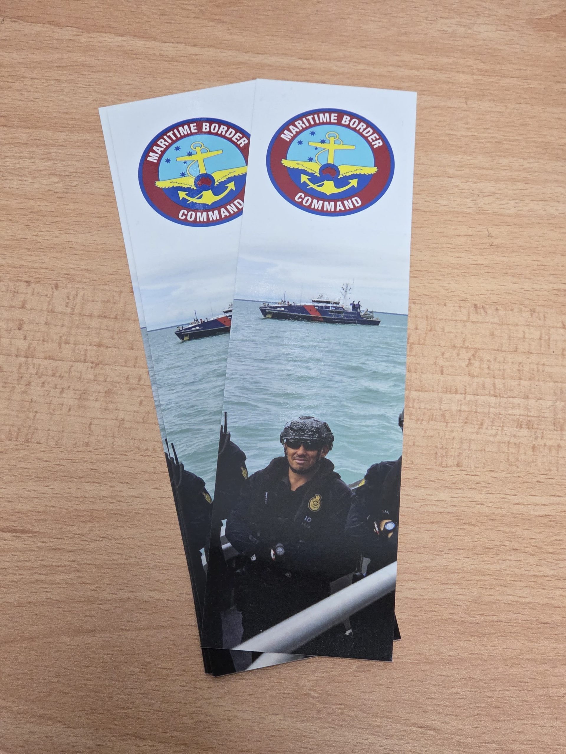 Two bookmarks with a maritime border security logo—ideal for Mail-Out Promotional campaigns.