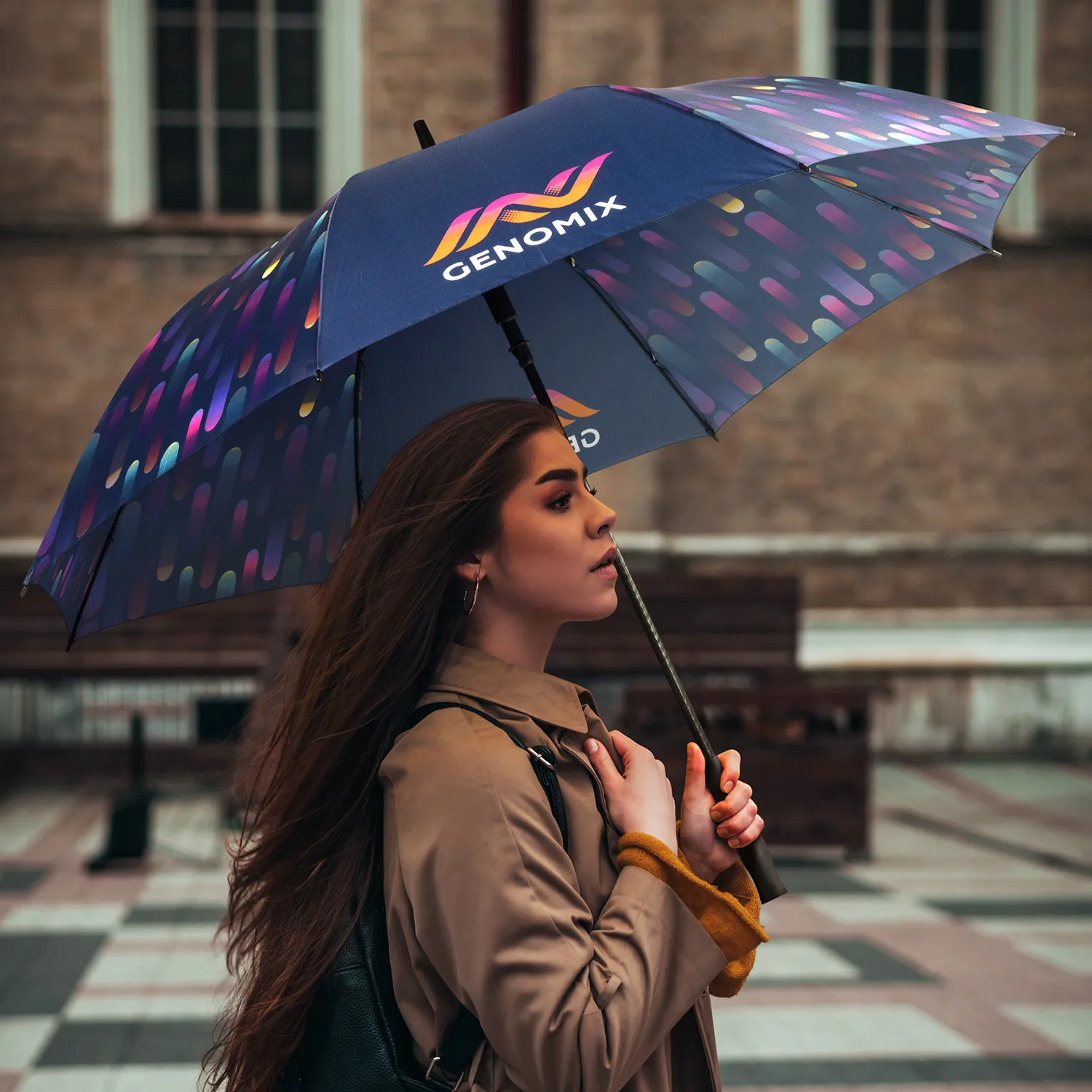 Woman with a GENOMIX umbrella, showcasing unbeatable benefits on a bustling city street.