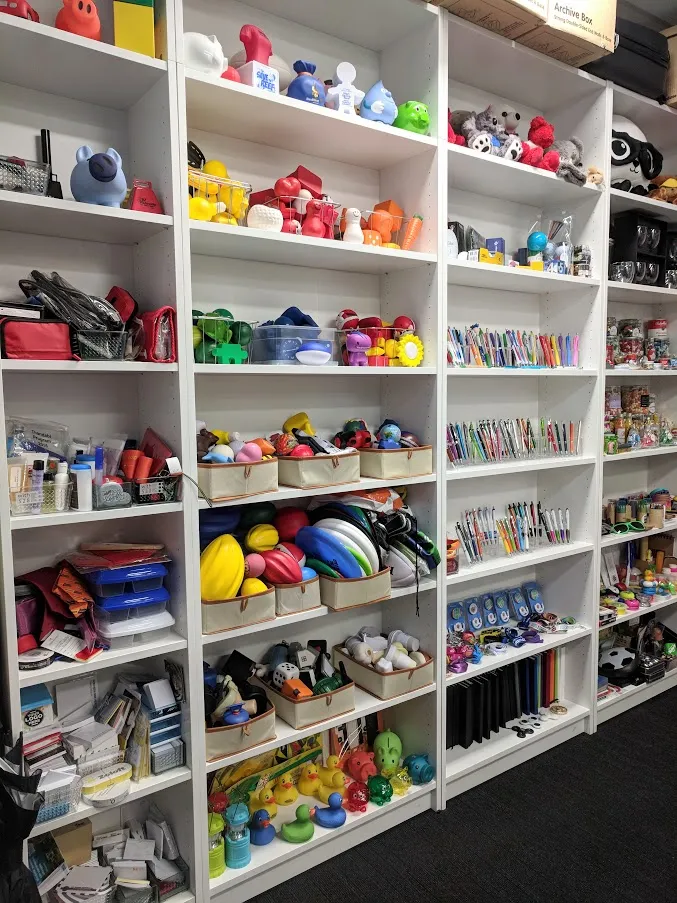 Showroom Wall of promotional items. Features cabinets filled with promotional products