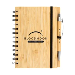 Wooden notebook with pen, perfect for diaries, labeled Bloodmoon Interactive with a crescent and star.