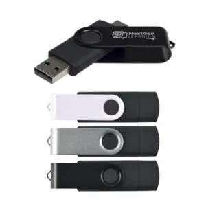 A display of four promotional USB flash drives in different colors: black, white, silver, and dark green. The black drive is open, showcasing the USB connector along with the NextGen Learning logo for enhanced brand awareness.