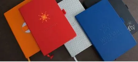 Five best-selling notebooks, available as exclusive 2023 conference promotional products, are arranged on a dark surface.
