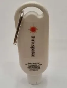 White bottle of SPF 30+ sunscreen lotion with a carabiner attached at the top.