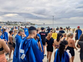People at the bondi beach wearing cape