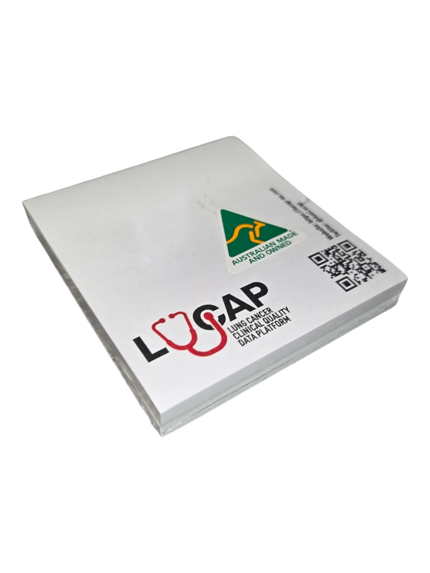 A stack of white sticky notes with a logo, QR code, and precise graphic design on top.