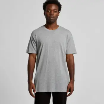 A man wearing an Ascolour T-shirt and black pants stands against a light gray background.