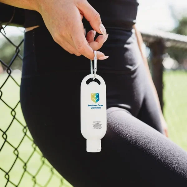 A person holds hand sanitizer clipped to their leggings—like what are promotional sunscreens?.