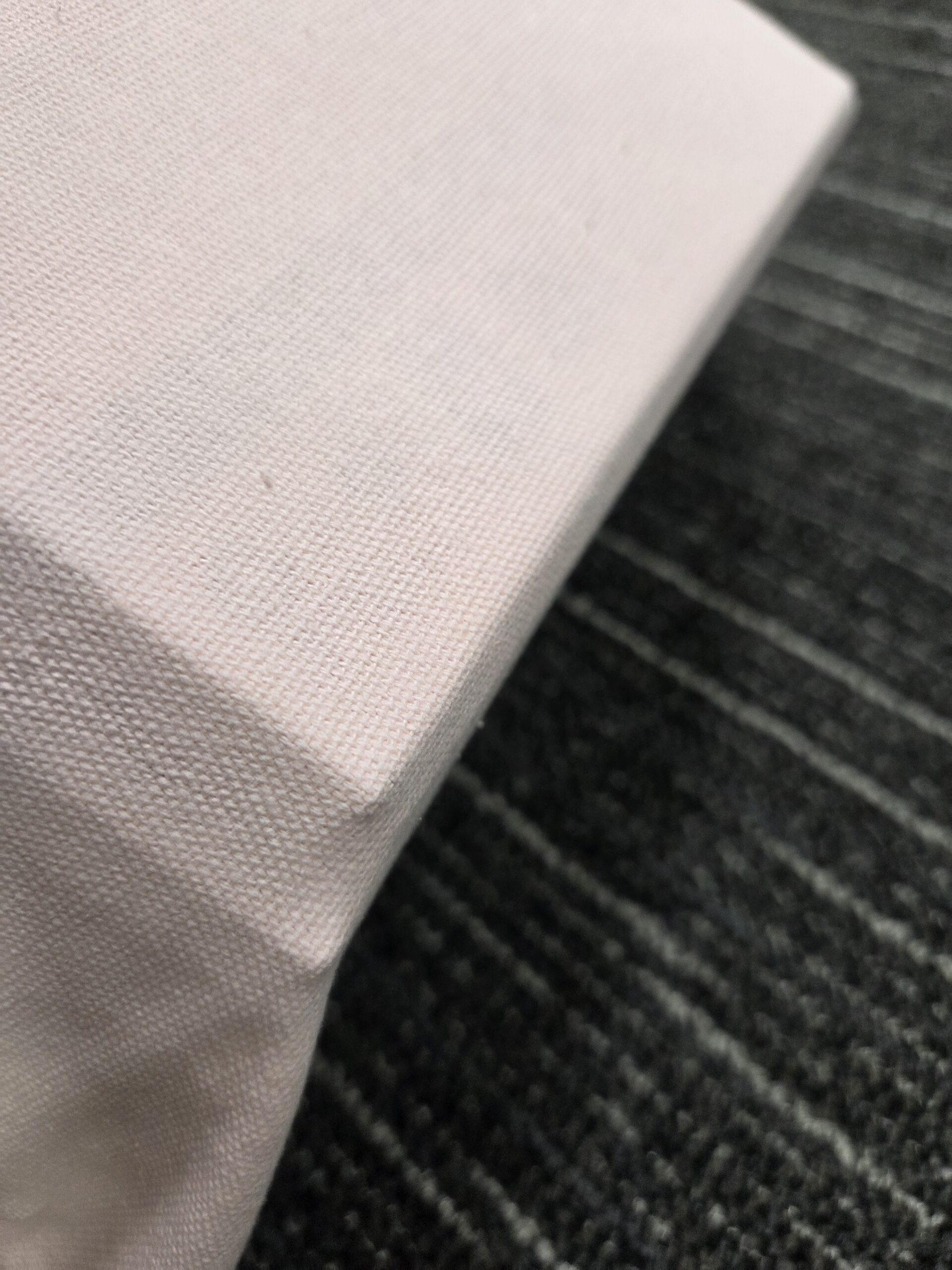 Close-up of a canvas, like those used in Conference Tote Bags, on a dark textured surface.