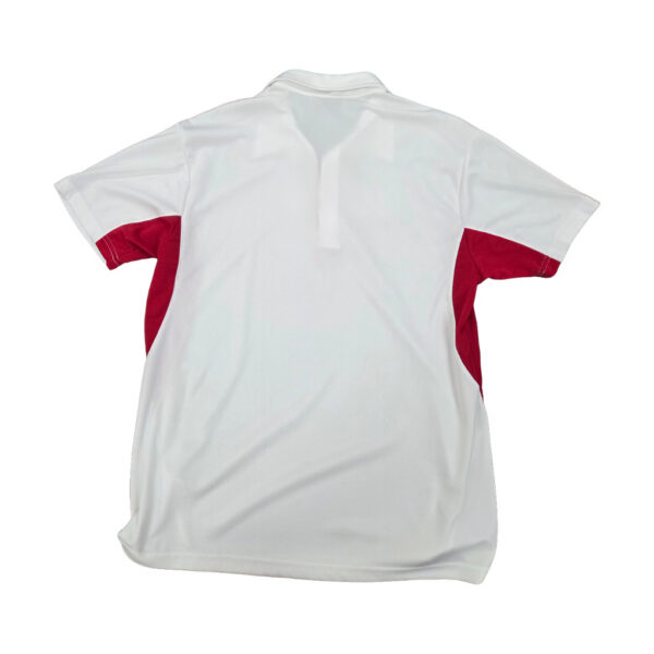 Back view of a white polo shirt with red side panels