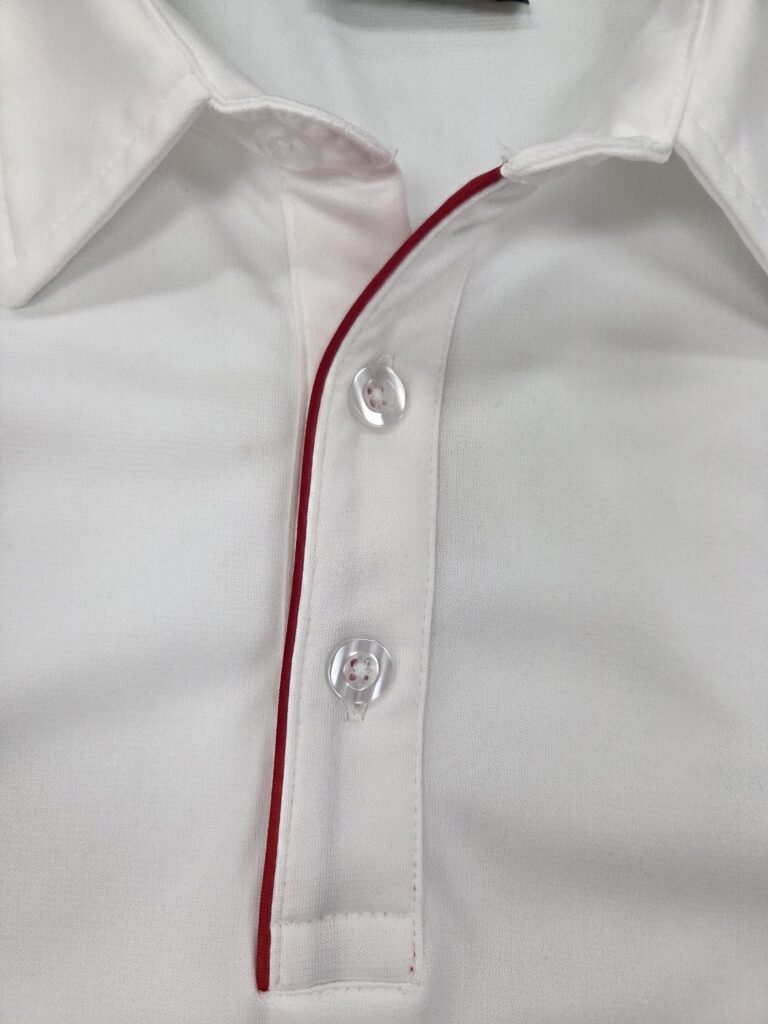 collar part of a white polo shirt with red lining.