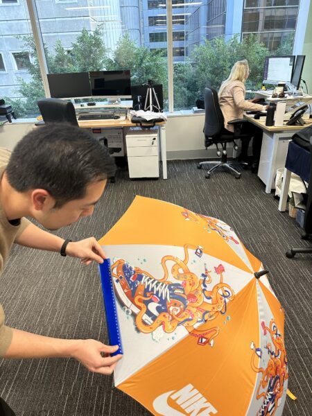 man measuring the logo of an umbrella