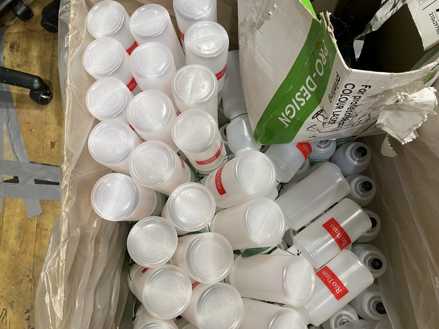A box filled with custom bottles, some labeled, all Australian made.