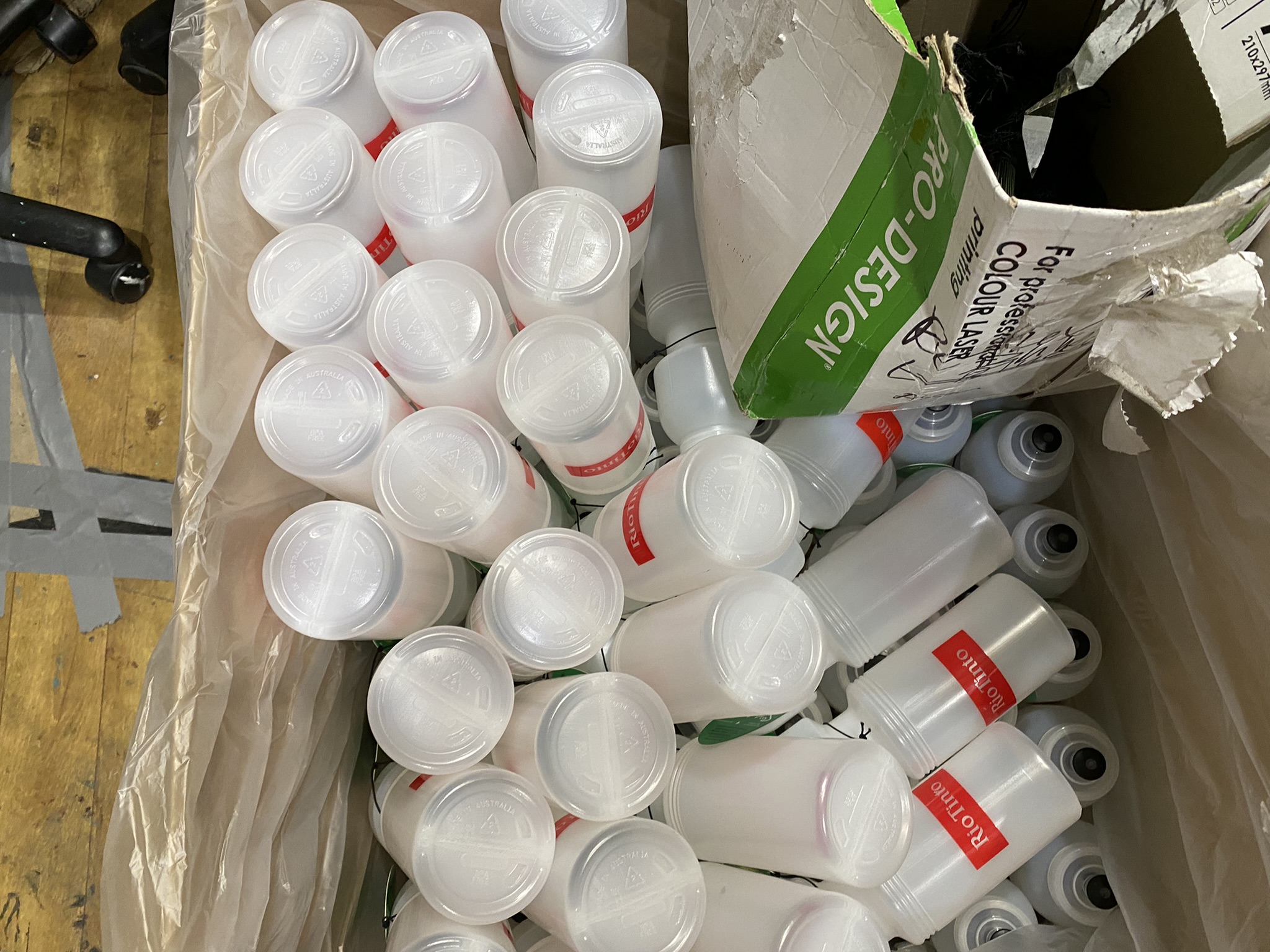 A box filled with custom bottles, some labeled, all Australian made.