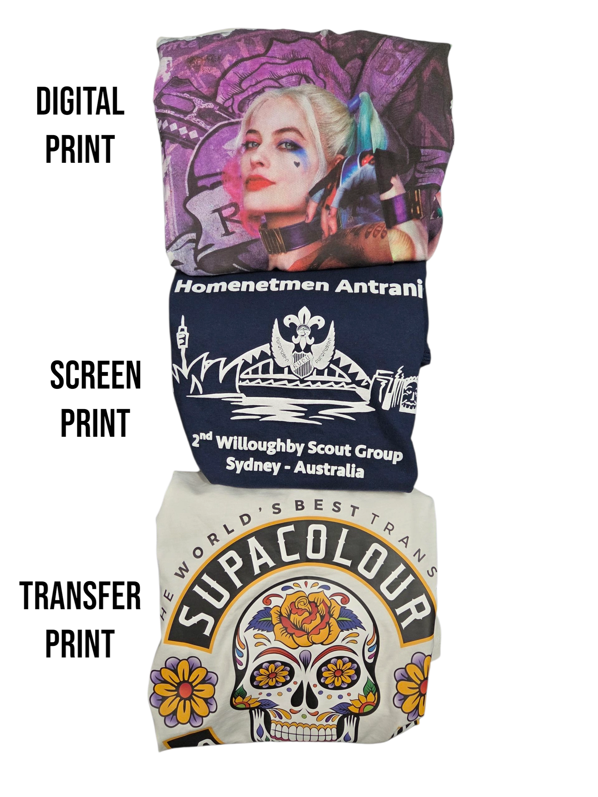 Three folded shirts with T-shirt printing: digital, screen, and transfer designs labeled on the side. Close up photograph of print quality