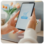 A person holding a phone with a payment screen, shopping cart, and business goals in mind.