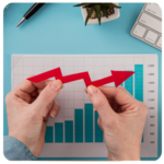Hands hold a red arrow over a bar graph, symbolizing business growth and achieving business goals.
