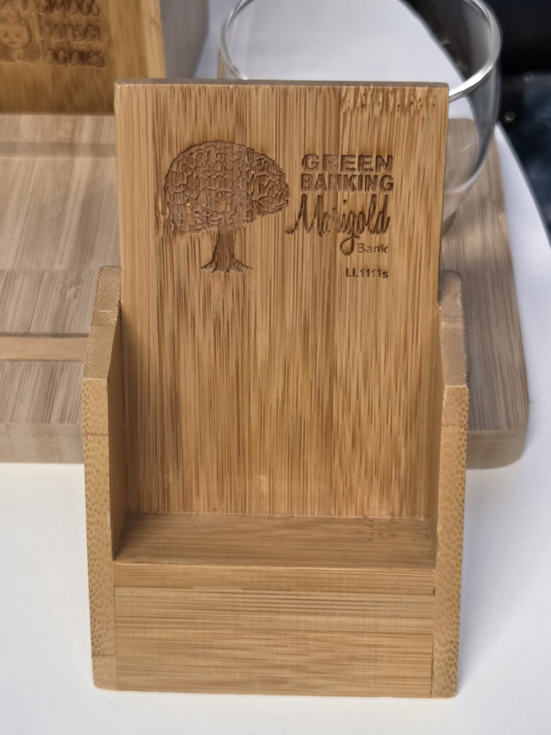 Whats New: Wooden phone stand engraved with a tree and GREEN BANKING Marigold Bank U.I.I.F.