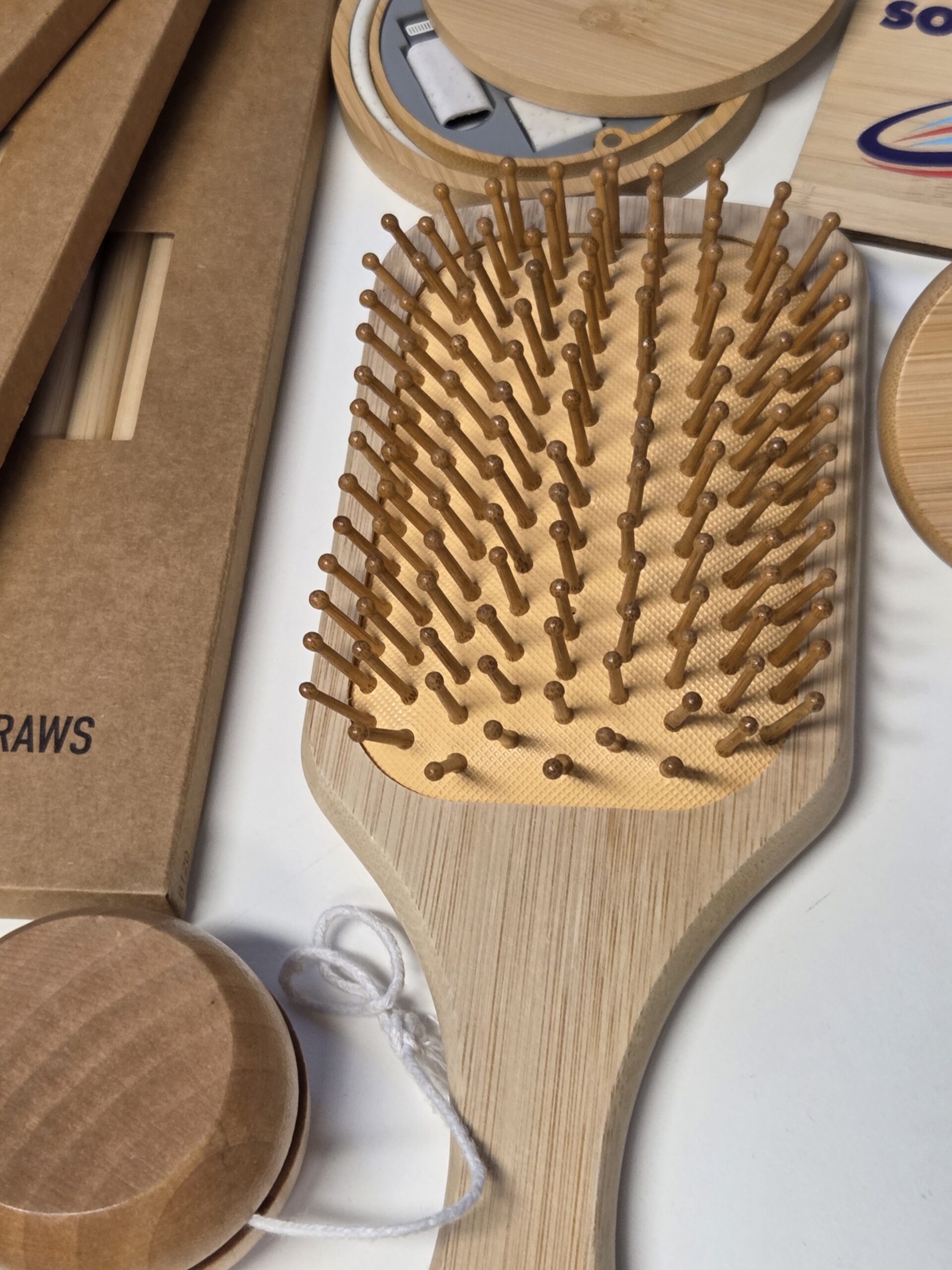 A Cubic Promote wooden paddle hairbrush with rounded bristles on a table, July 2025.
