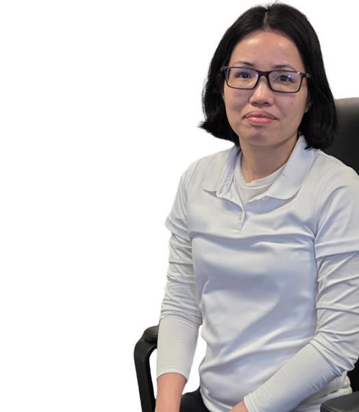 Woman with glasses in a white shirt seated on a chair