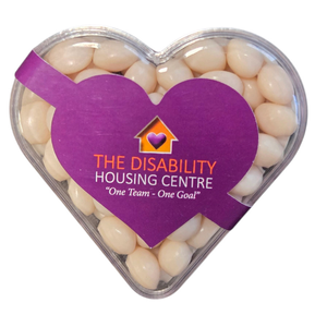 Heart-shaped box of white jelly beans with a purple label for The Disability Housing Centre.