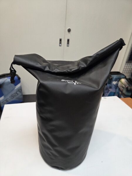 Black roll-top dry bag standing upright, perfect for use as sports gym bags, with subtle logo.