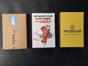 Three branded card boxes for promotional games: SAP Taulia, Dynamic Logistics Hero, Prosegur.