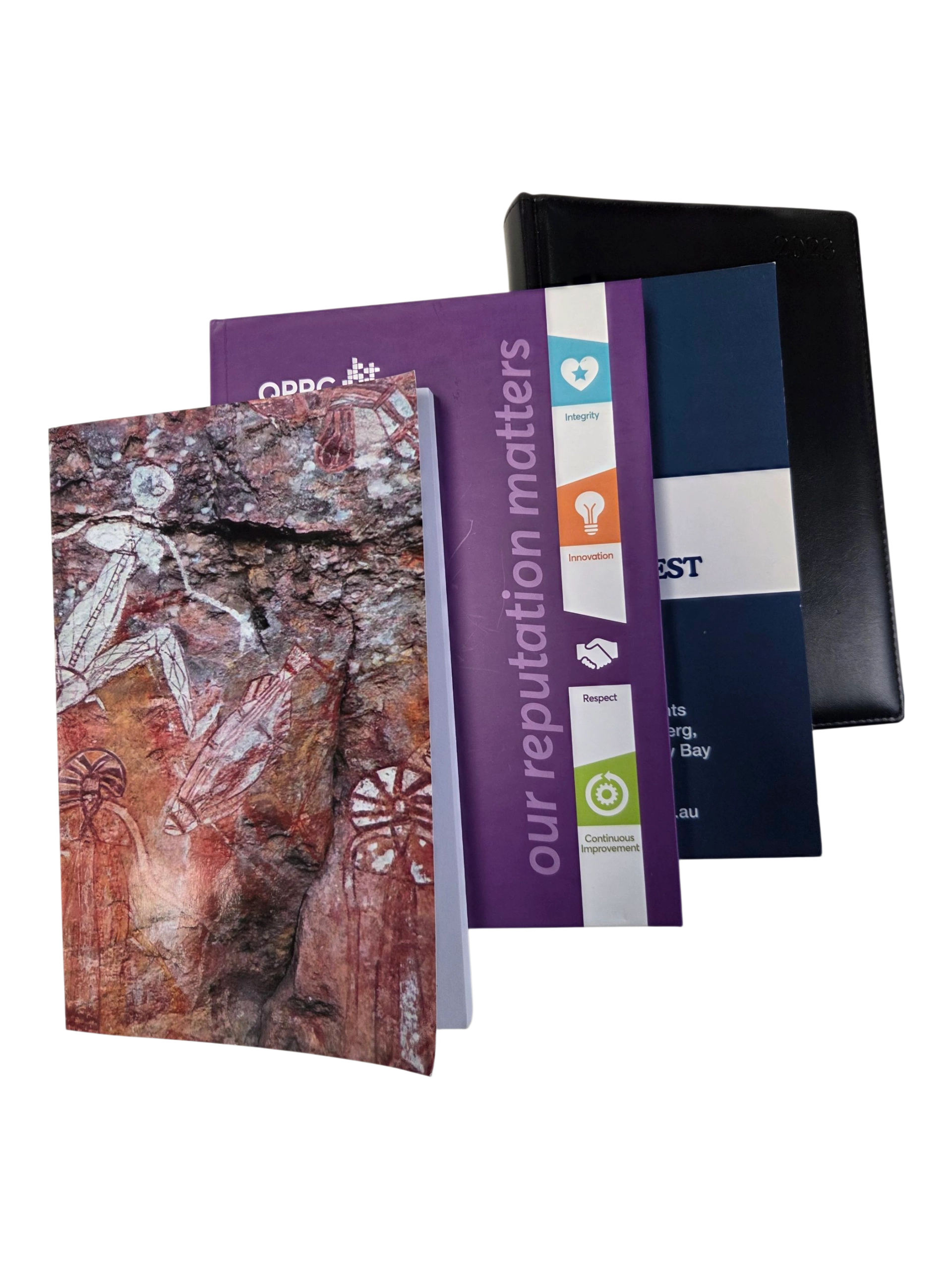 Four assorted notebooks stacked—ideal for your buying guide for diaries or branded materials.