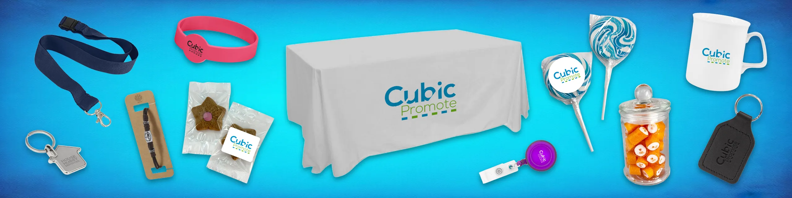 Promotional items with Cubic Promote logo on blue background, including mug, lanyard, and sweets.