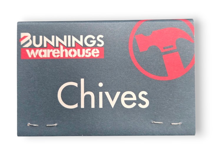 A Bunnings Warehouse packet labeled Chives with a red hammer and promotional seedsticks.