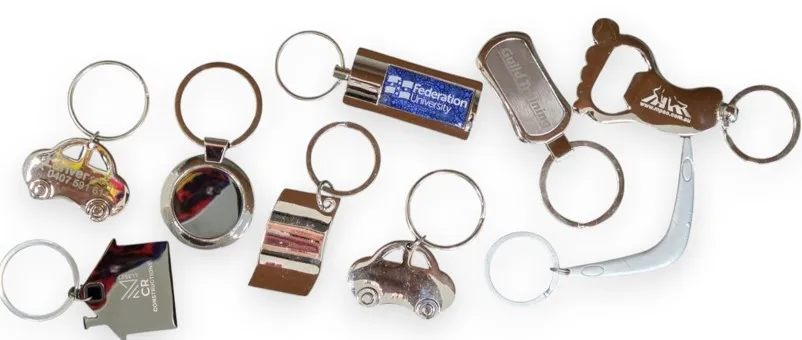 Assorted metal vs plastic keyrings in fun shapes, like cars and a boomerang.