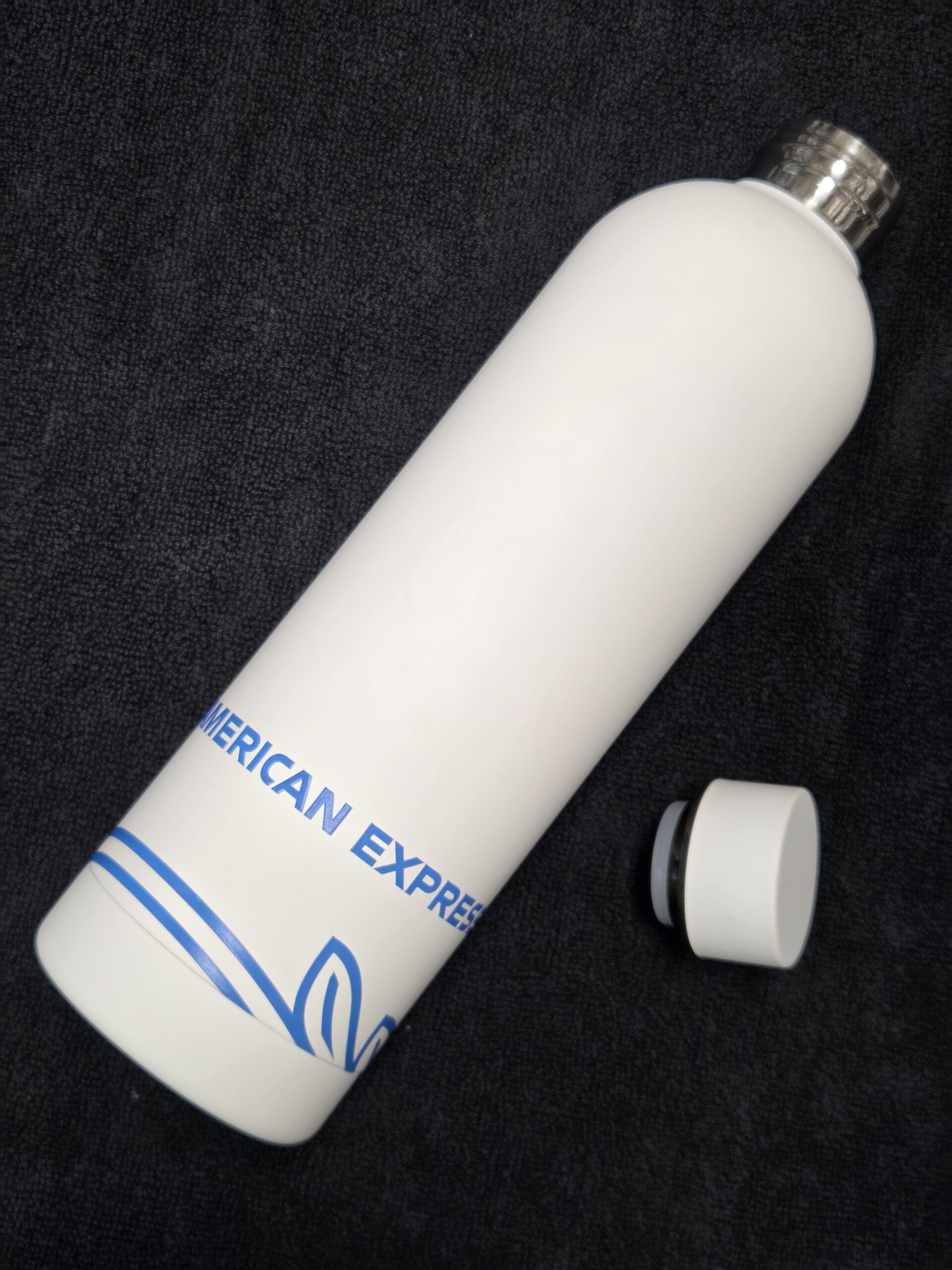 American Express bottle with white lid on the side