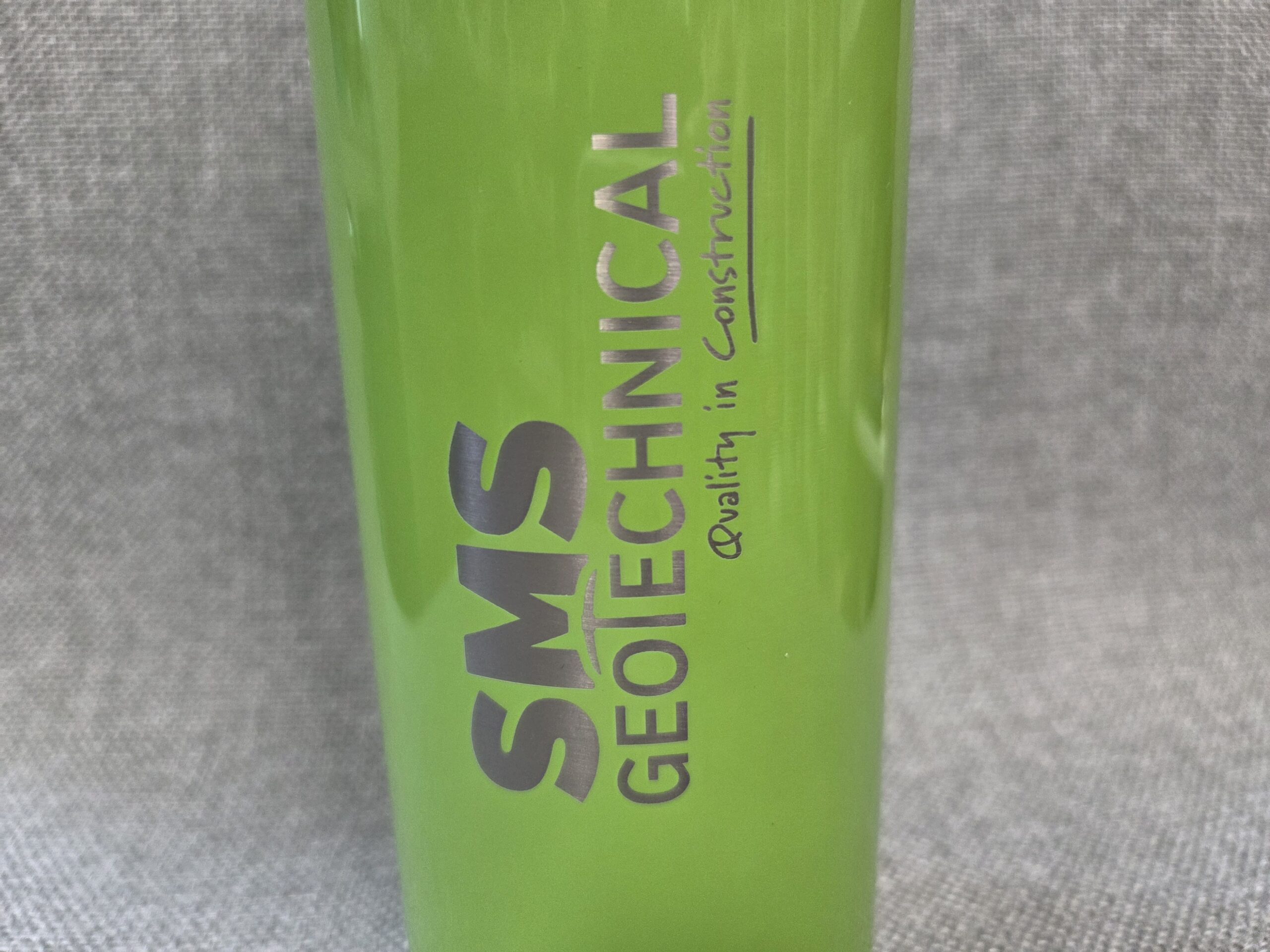 neon yellow bottle and a logo of the SMS Geotechnical