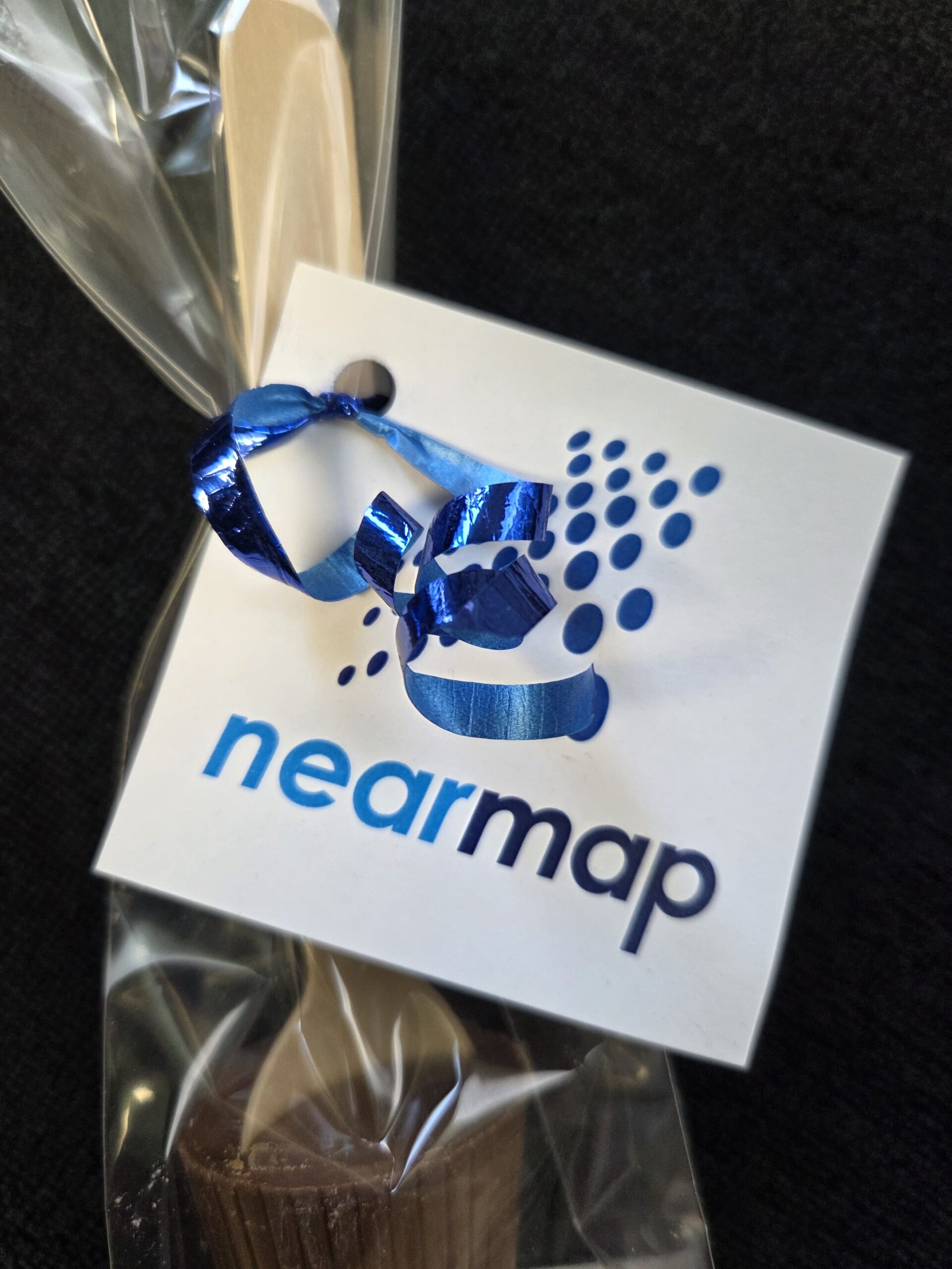 A wrapped treat with a Nearmap tag, blue ribbon, and "Client Story" on a black background.