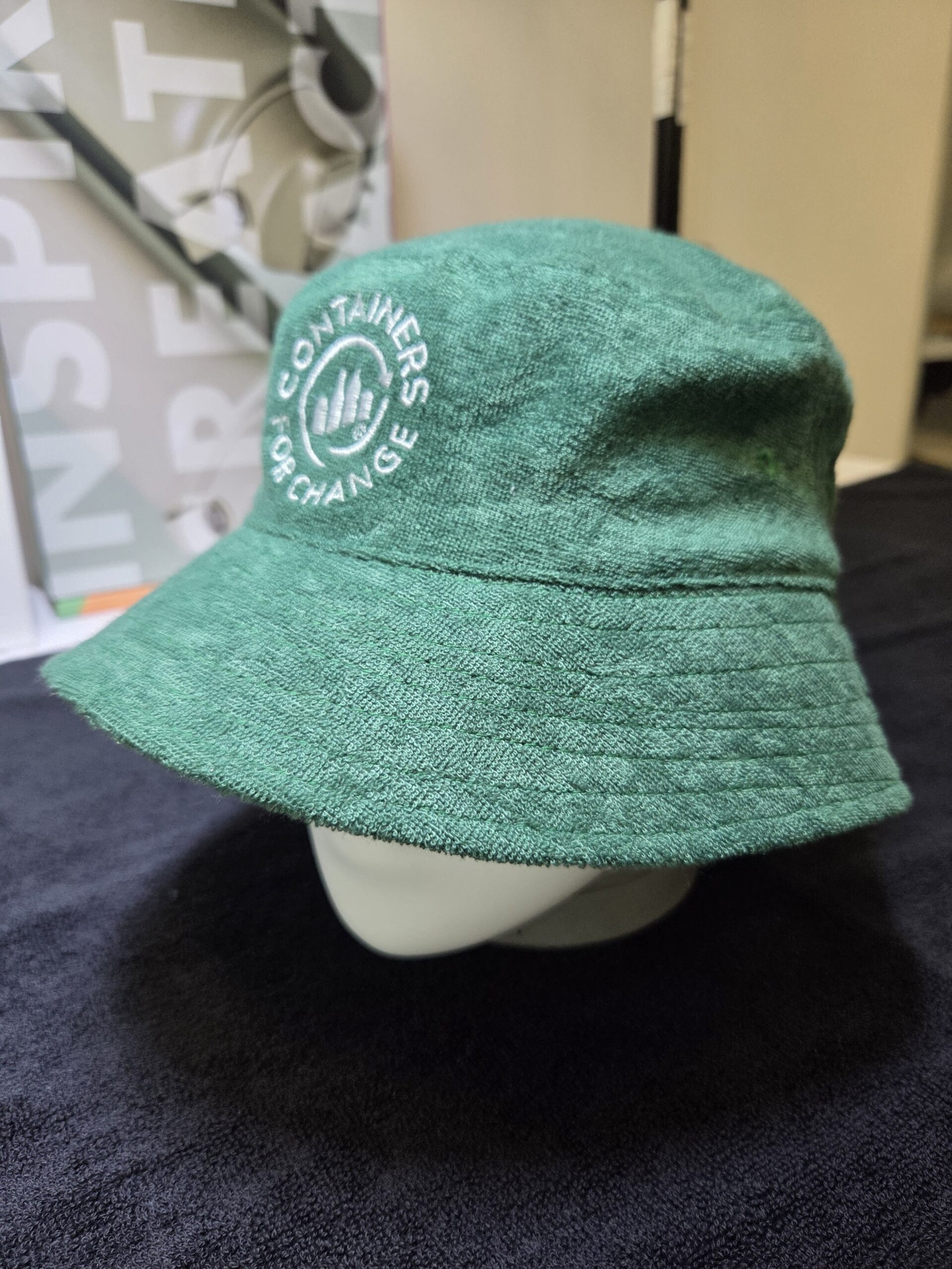 green bucket hat on a mannequin