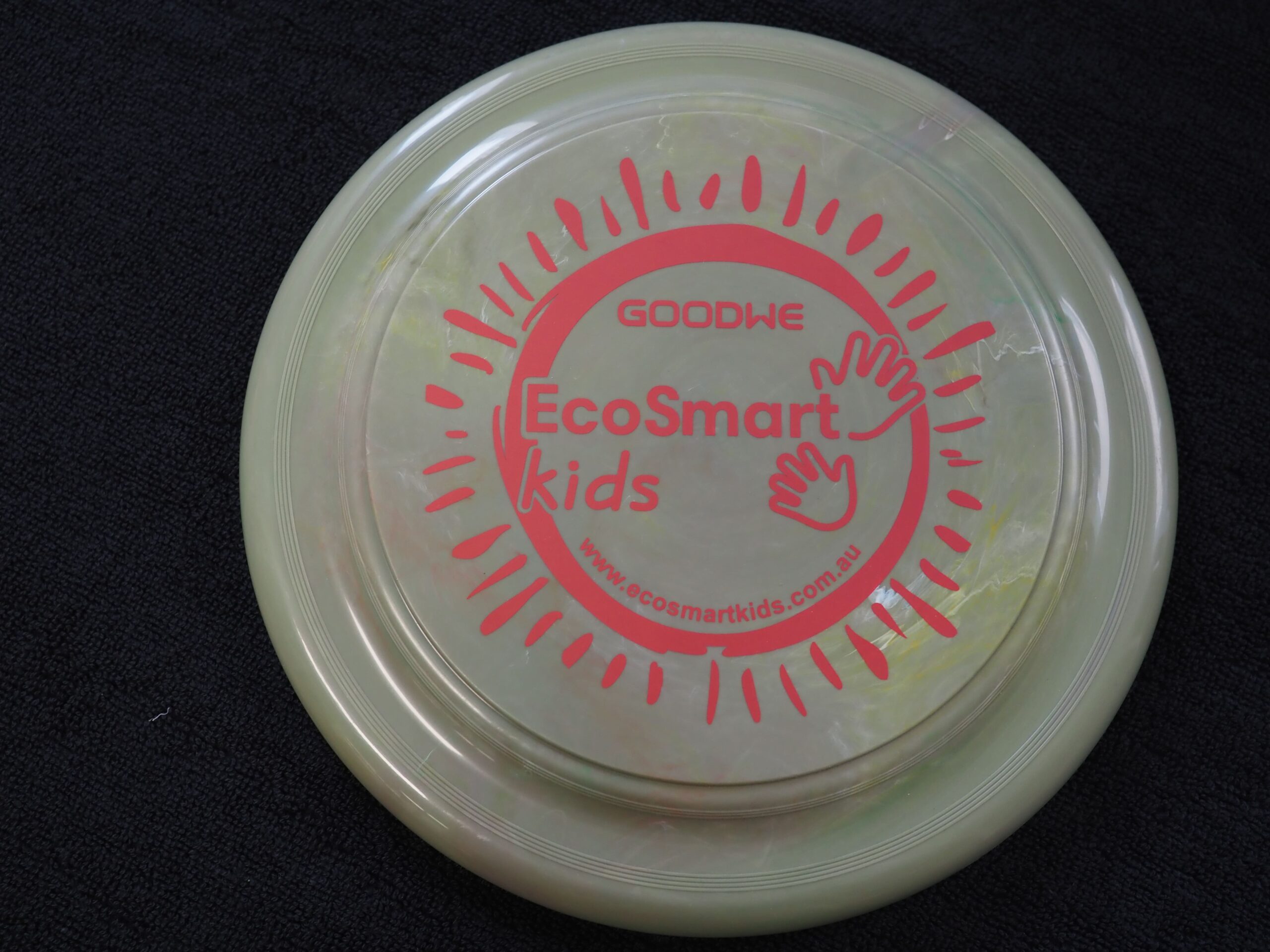 A pale disc with GoodWe solar inverters and pink handprints on a dark surface.