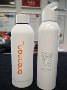 Two white drink bottles—ideal as corporate gifts—feature brennan_ and a koala with CAIRNS.