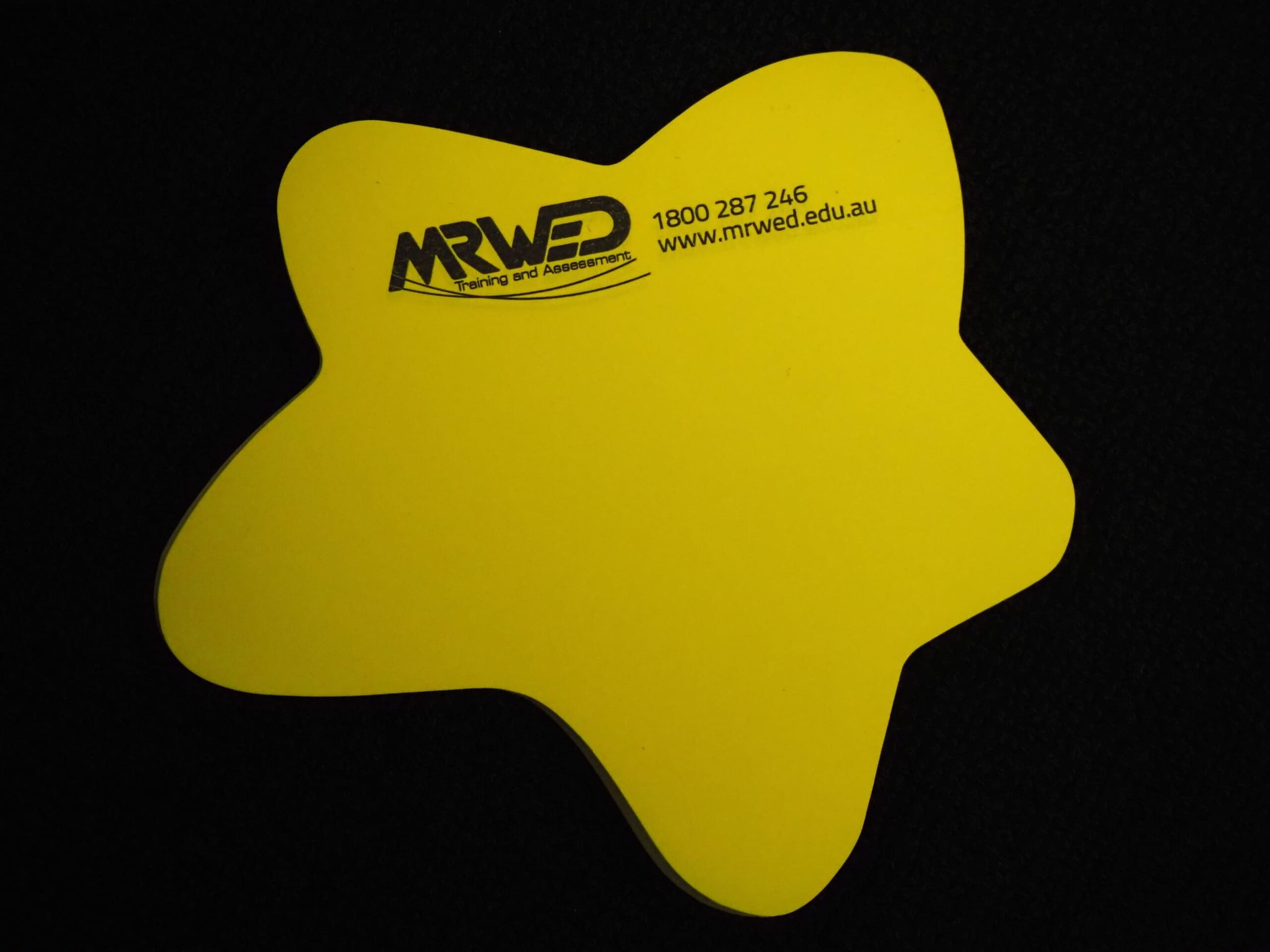 Yellow star-shaped sticky note with MRWED Training logo and website on a black background.