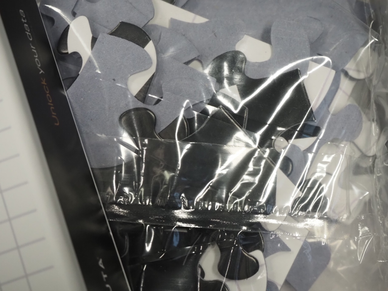 Jigsaw puzzle pieces in a clear plastic bag, like a Happy Client with an Immuta solution.