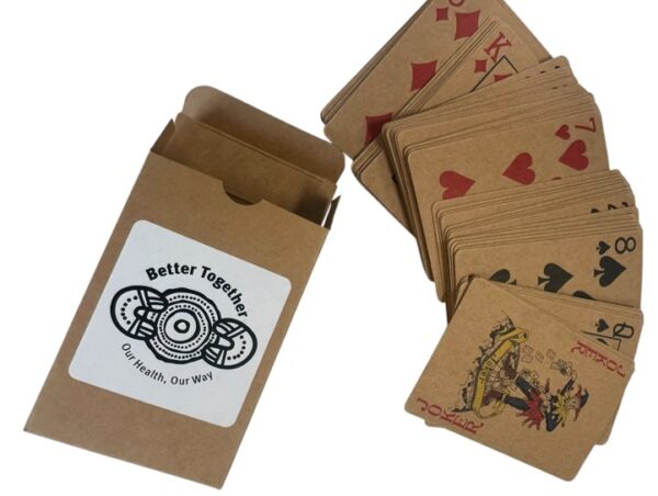 Brown playing cards—one of our funnest promotional items—spread out by a labeled box.