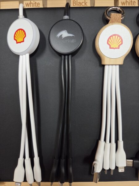 Three multi-connector charging cables, popular promotional items, hang on a display board.