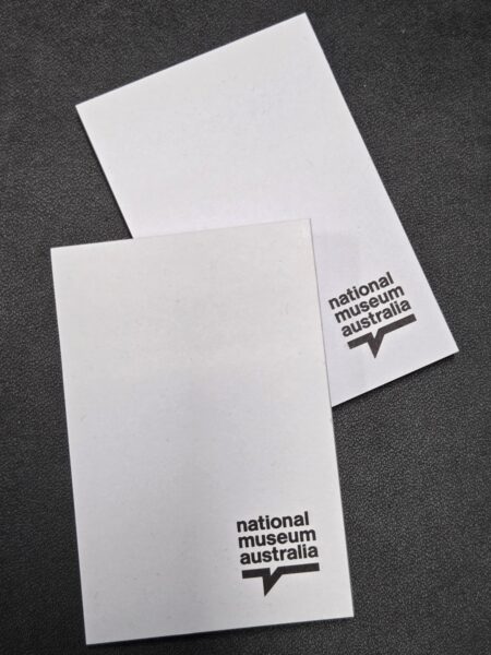 Two white note cards featuring the National Museum Australia logo printed in black text.