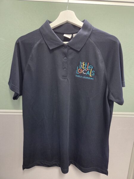 Dark polo shirt with new rebrand Little Locals Early Learning logo, on a white hanger.