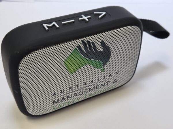 Black portable speaker with buttons on top, Australian Management logo, perfect for gifts.
