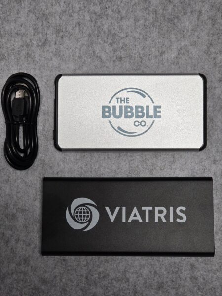 Two branded power banks and a black USB cable—perfect as practical Christmas gifts.
