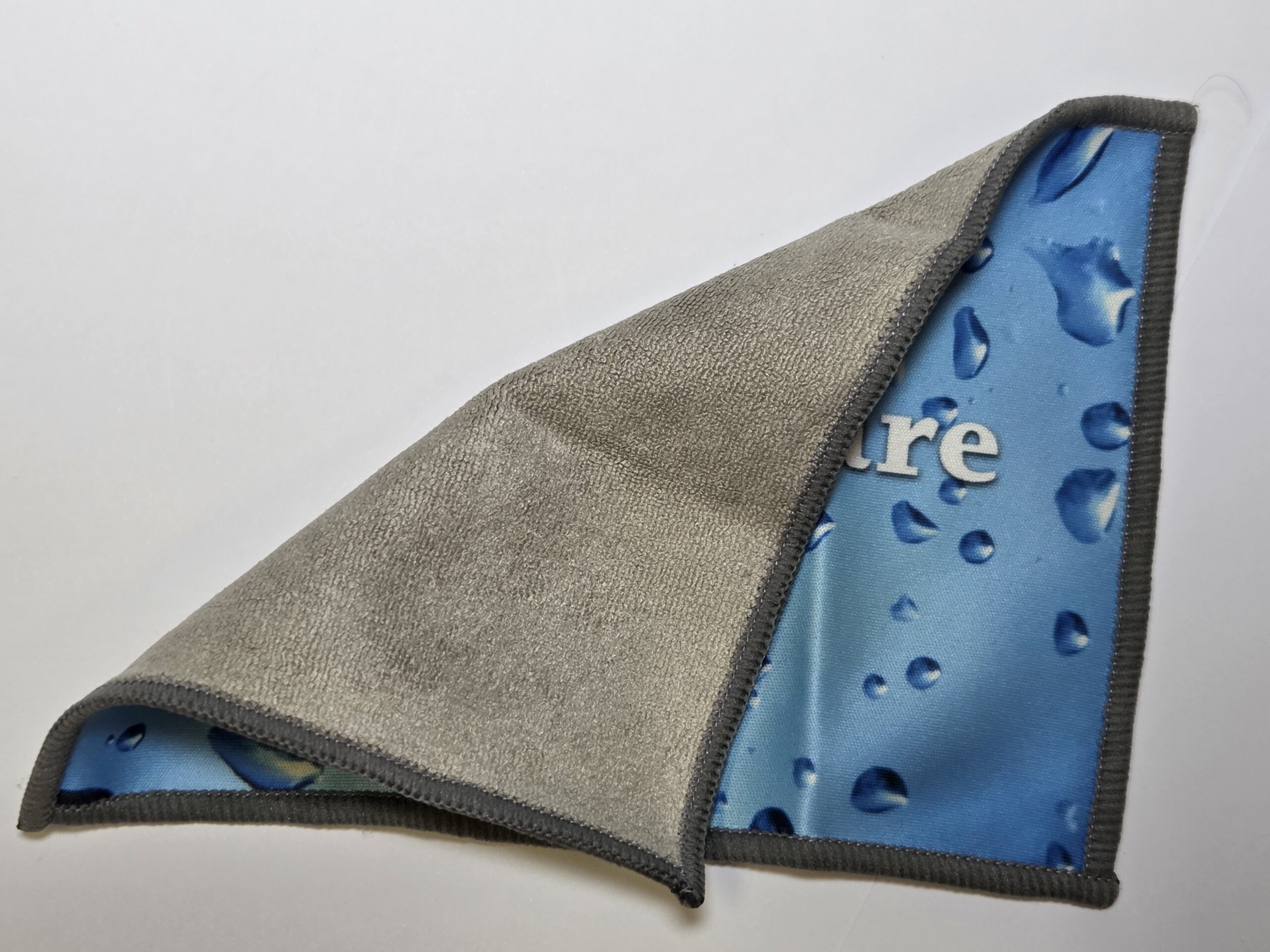 A Rockwell microfiber cloth flipped to reveal a blue side with water droplets and white text.
