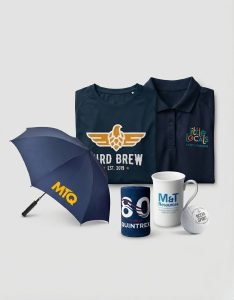 Assorted promotional products Brisbane: shirts, umbrella, mug, stubby holder, golf ball, coaster.
