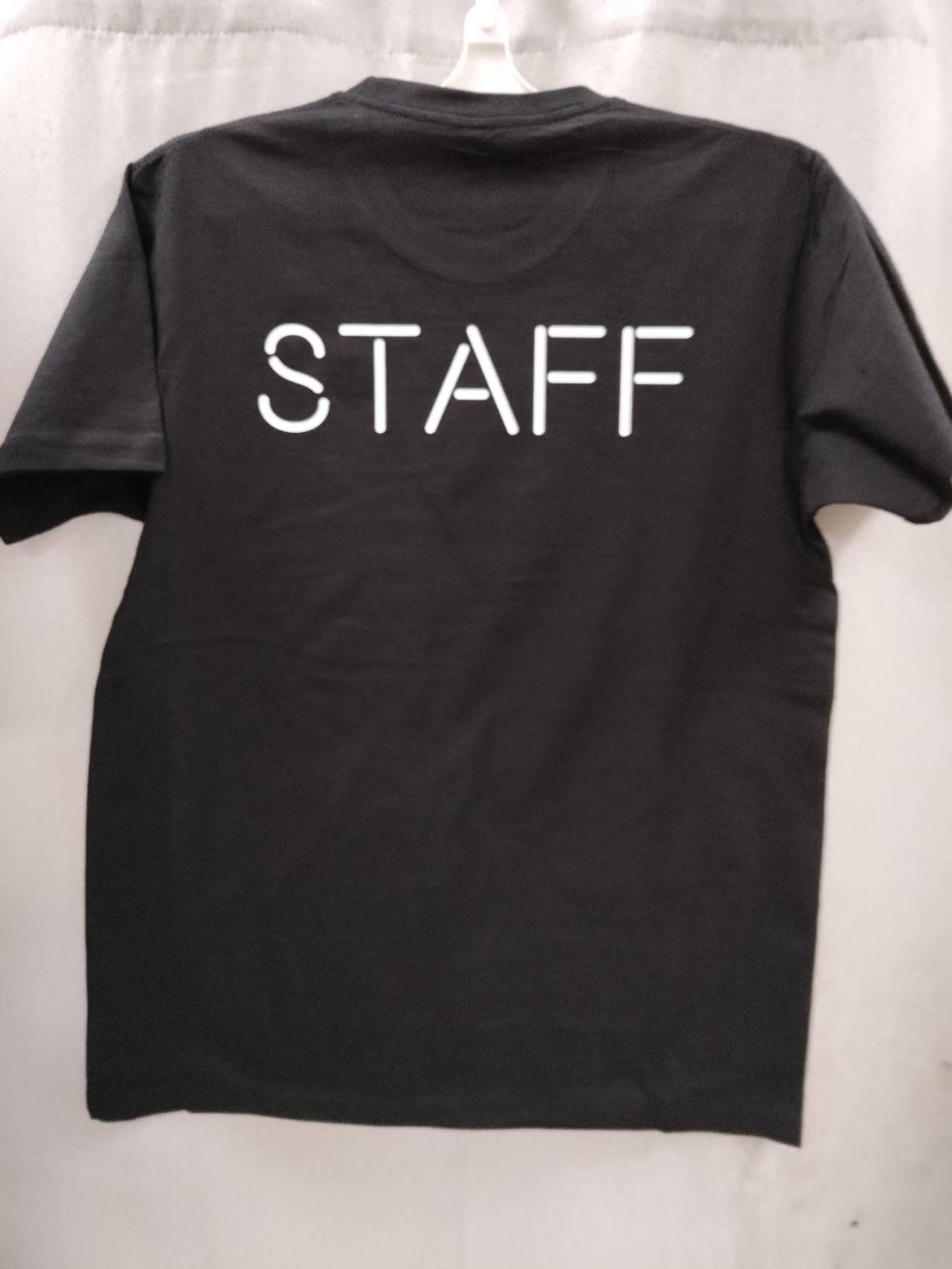 Black t-shirt with STAFF print, perfect for Dirty Harry’s Bar & Grill team members.
