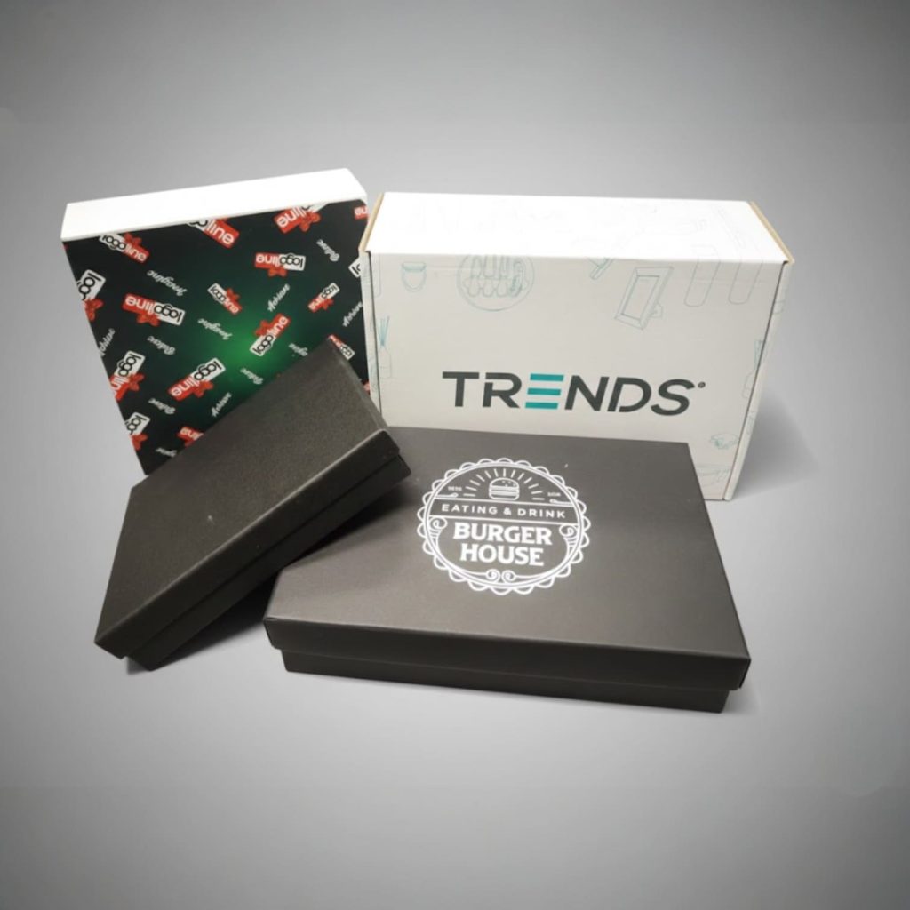 Premium Promo Packs: Four branded boxes, black and white, on a grey Australian B2B backdrop.