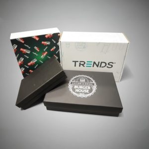 Premium Promo Packs: Four branded boxes, black and white, on a grey Australian B2B backdrop.