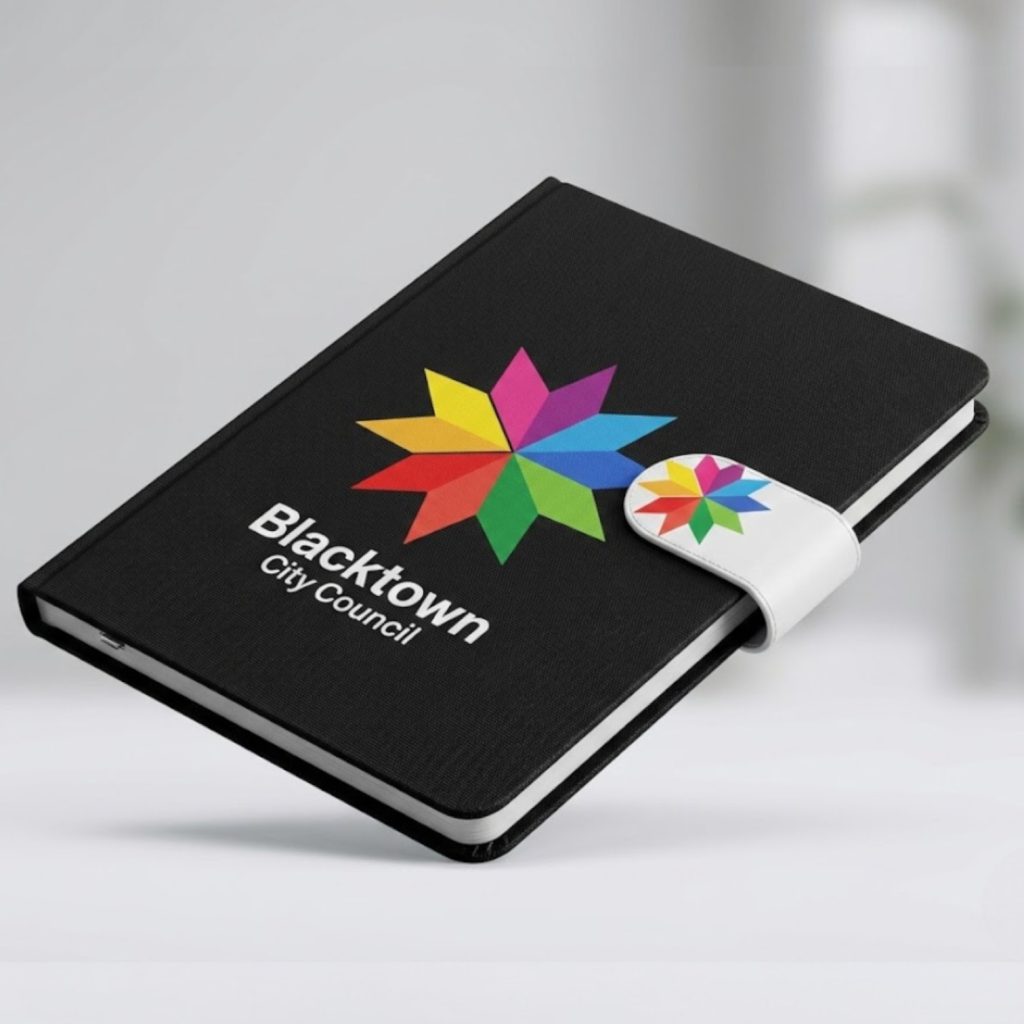 A black promotional notebook with Blacktown City Council and a colorful star logo on the cover.